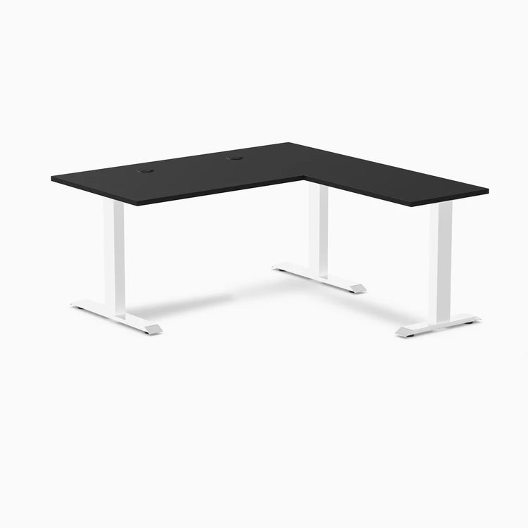 Black laminate L-shape office desk with white steel frame and grommets.