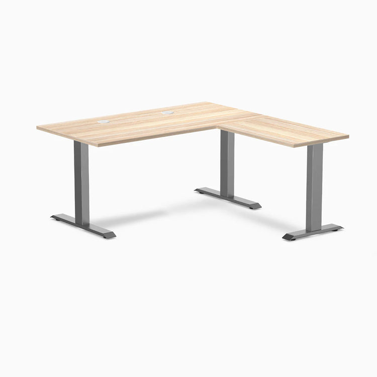 Classic Oak L-shape office desk with Space Gray steel frame and grommets.
