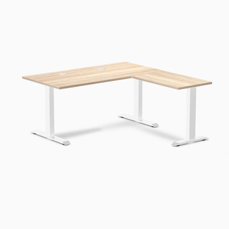 Classic Oak Desky Zero Laminate L-shape office desk with white steel frame and grommets.