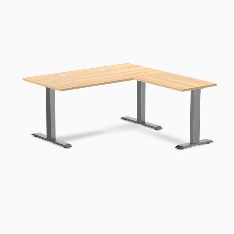 Desky Zero L-shape office desk with Sublime Teak laminate top, Space Gray steel frame, and grommets.