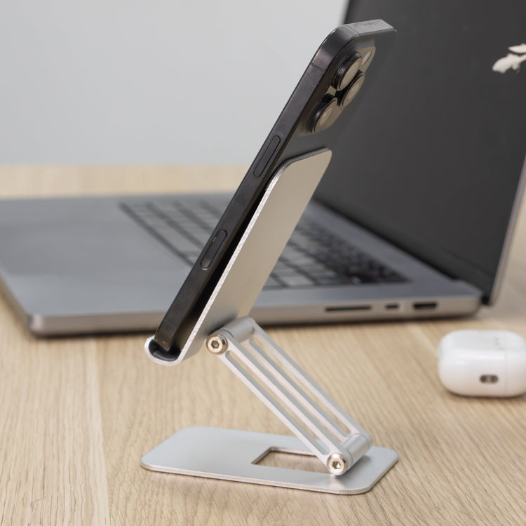 Silver phone stand on top of desk