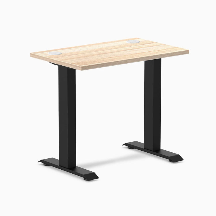 Desky Zero Mini fixed-height desk with Classic Oak top, 32x20 inches, grommets, and matte black legs.