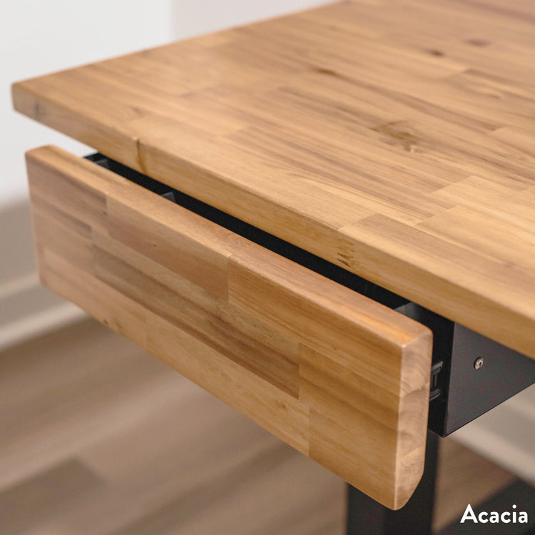 Minimal acacia wood under-desk drawer with a solid wood front panel and hidden handle, complementing a wooden desk.