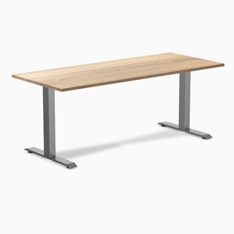 Desky Zero fixed-height office desk with White Ash hardwood top and Space Gray steel frame.