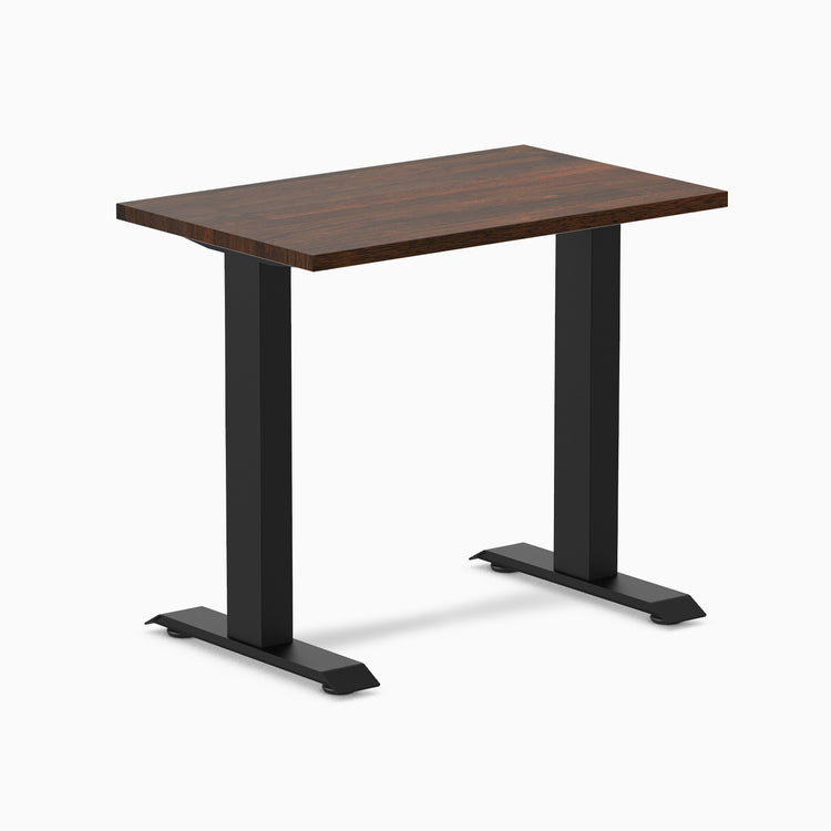 Desky Zero Mini fixed-height desk with dark walnut rubberwood top and matte black frame.