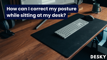 How can I correct my posture while sitting at my desk?