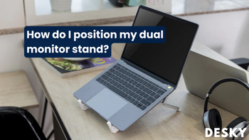 How do I position my dual monitor stand?