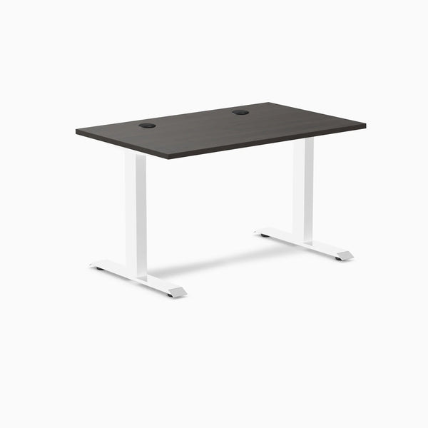 Desky Zero laminate office desk with burnished wood top, white steel frame, and two grommets.