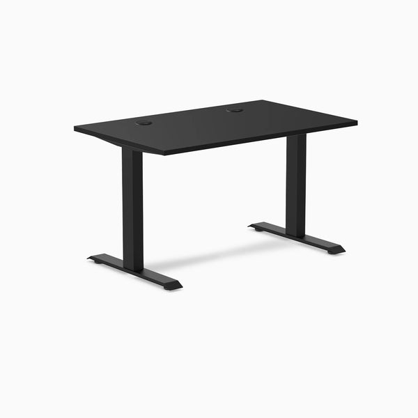 Desky Zero black laminate office desk with matte black steel frame and two grommets.