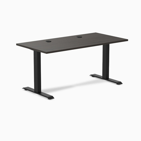 Desky Zero fixed-height office desk with burnished wood laminate top, grommets, and matte black steel frame.