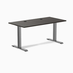 Desky Zero fixed height office desk with burnished wood laminate top, grommets, and space gray steel frame.