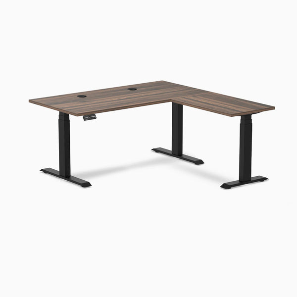 Desky L-Shape Laminate Sit Stand Desk in Jarrah Legno with Matte Black legs and grommets.