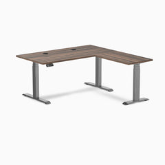 Desky L-Shape Laminate Sit Stand Desk in Jarrah Legno with Space Gray legs and grommets.