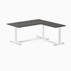 Desky Zero L-shape office desk with burnished wood laminate top, white steel frame, and grommets.