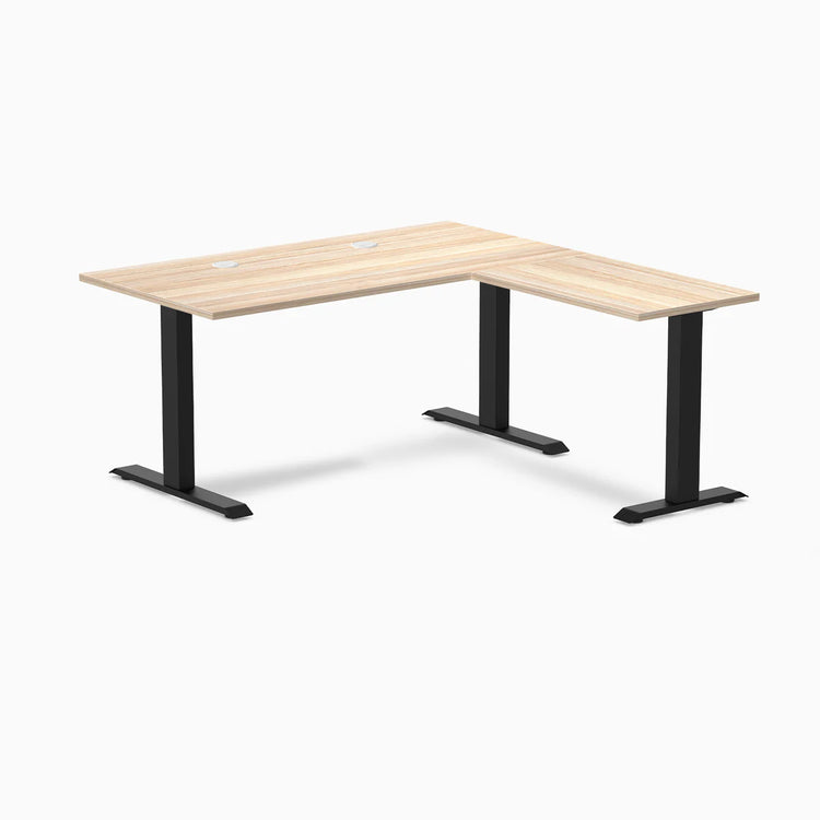 Classic Oak L-shape office desk with a laminate top, black steel frame, and grommets.