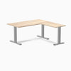 Classic Oak L-shape office desk with gray steel frame and grommets.
