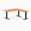 Prime Oak Desky Zero Laminate L-shape office desk with black steel frame and grommets.