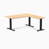 Desky Zero L-shape office desk with Sublime Teak laminate top, matte black steel frame, and grommets.