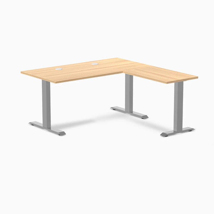 Sublime Teak laminate L-shape office desk with gray steel frame and grommets.