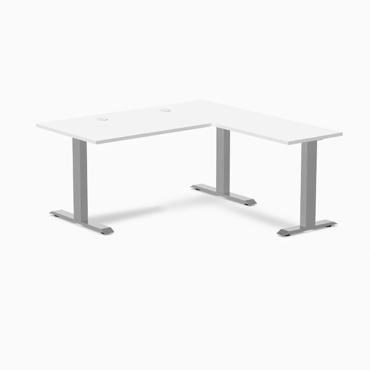 White L-shape laminate office desk with gray steel frame and grommets.