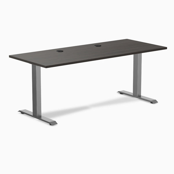 Desky Zero fixed height office desk with burnished wood laminate top, grommets, and space gray steel frame.