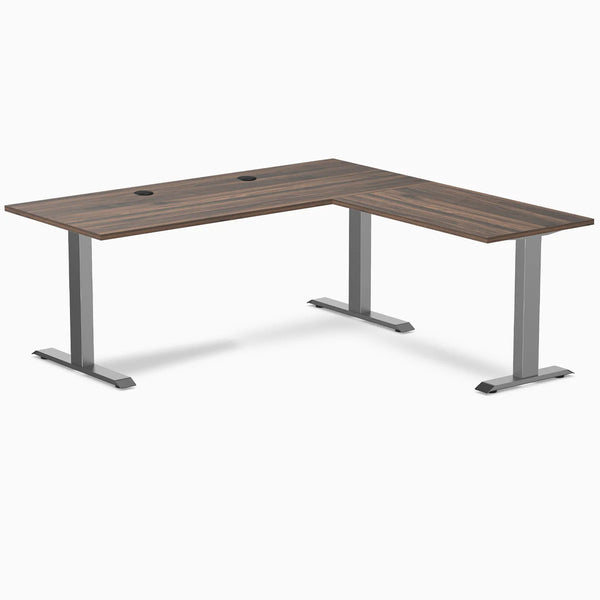 Desky Zero L-shape office desk with Jarrah Legno laminate top, Space Gray steel frame, and grommets.