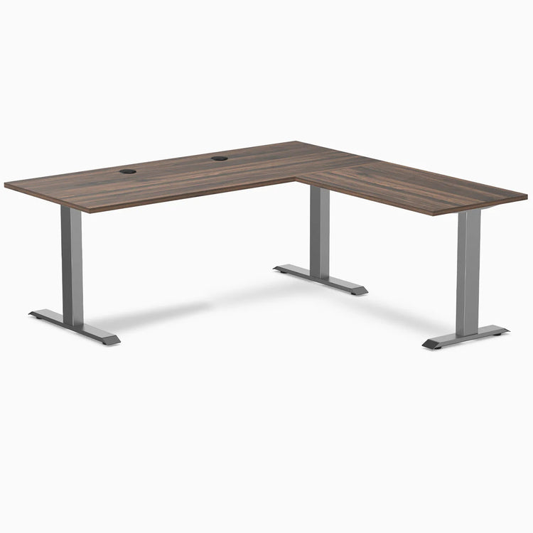 Desky Zero L-shape office desk with Jarrah Legno laminate top, Space Gray steel frame, and grommets.