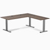 Desky Zero L-shape office desk with Jarrah Legno laminate top, Space Gray steel frame, and grommets.