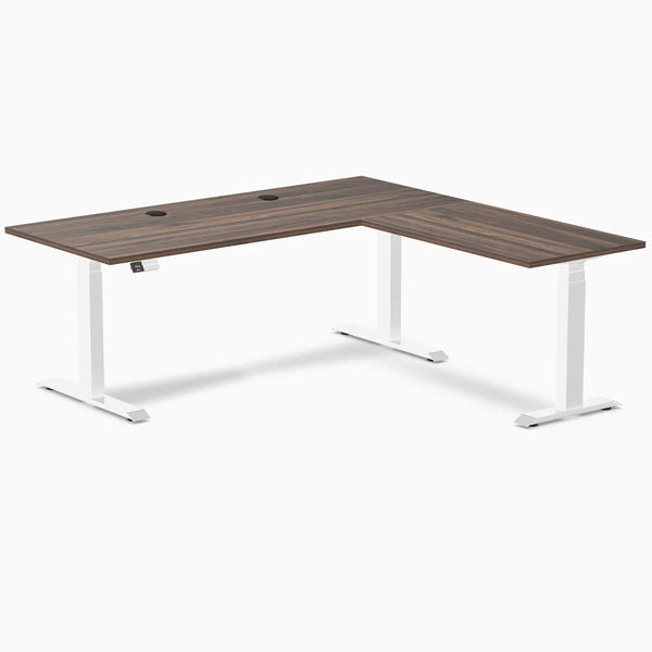 Desky L-Shape Laminate Sit Stand Desk in Jarrah Legno with white legs and grommets.