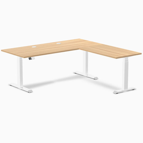 Desky L-Shape Laminate Sit Stand Desk in Sublime Teak with white frame and grommets.