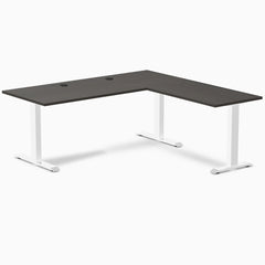 Desky Zero L-shape office desk with burnished wood laminate top, white steel frame, and grommets.