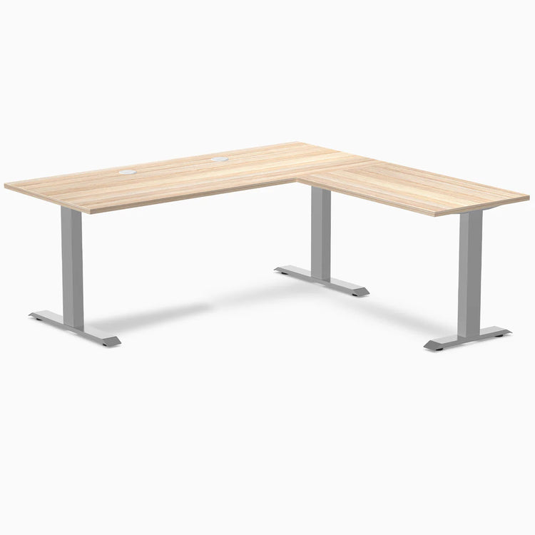 Classic Oak L-shape office desk with gray steel frame and grommets.