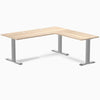 Classic Oak L-shape office desk with gray steel frame and grommets.