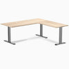 Classic Oak Desky Zero Laminate L-shape office desk with Space Gray steel frame and grommets.