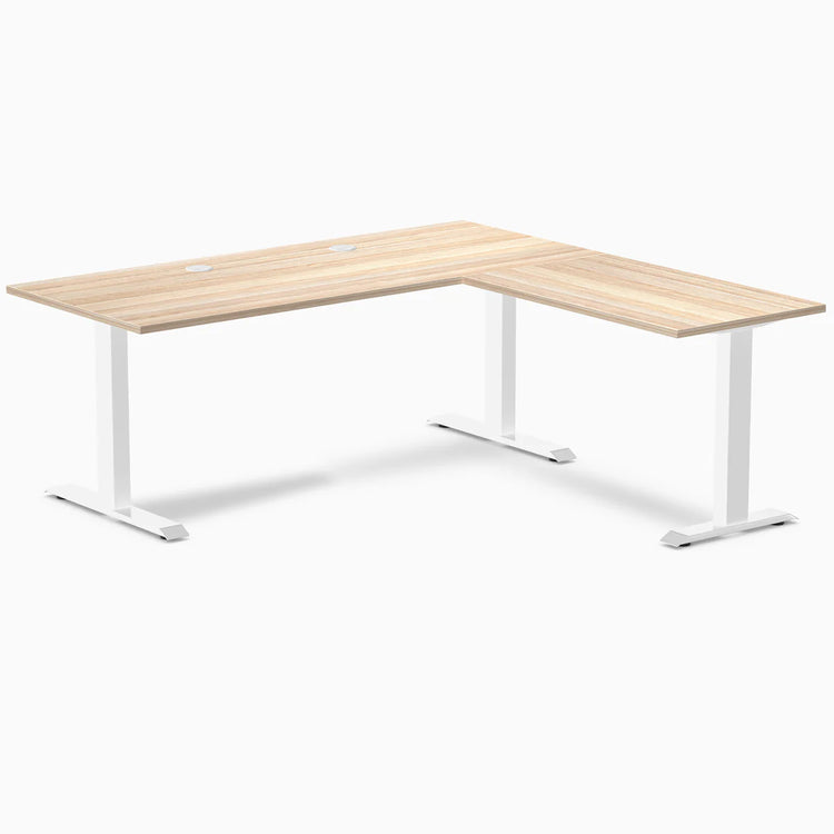 Classic Oak L-shape office desk with white steel frame and two grommets on a white background.