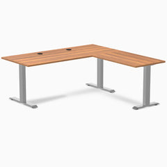 Prime Oak L-shape office desk with gray steel frame, grommets, and minimalist design.