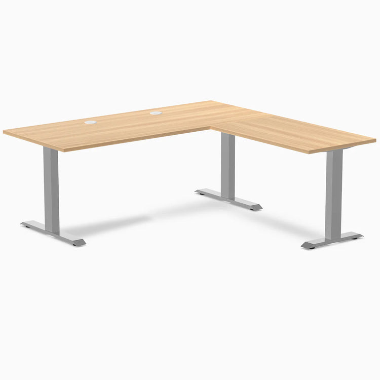 Sublime Teak L-shape laminate office desk with gray steel frame and grommets.