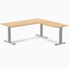Sublime Teak L-shape laminate office desk with gray steel frame and grommets.
