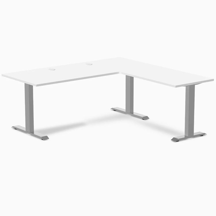 White laminate L-shape office desk with gray steel frame and grommets.