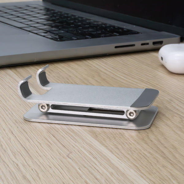 Silver phone stand folded on top of table