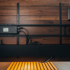 Black integrated cable channel and power set up under desk