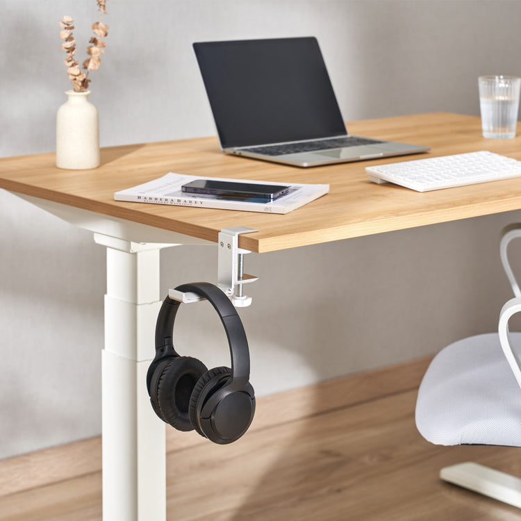 Silver headphone hanger attached to desk