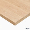 Close-up of a light maple hardwood desk surface with natural wood grain, showing a rounded corner.