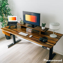 Pheasantwood hardwood standing desk with black legs, monitor riser, and integrated drawer.