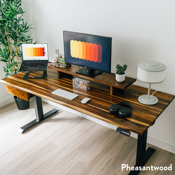 Pheasantwood hardwood standing desk with black legs, monitor riser, and integrated drawer.