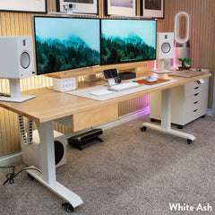 White Ash Desky Dual Hardwood Sit Stand Desk with dual monitors, speakers, and mobile storage.