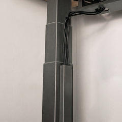 Black Desky magnetic cable management attached to desky frame legs 