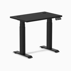 Black Desky Dual Mini sit-stand desk, 32x20 inch, with grommets and matte black frame.