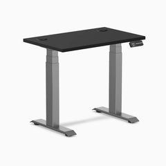 Black 32x20 inch Desky Dual Mini sit-stand desk with space gray legs and grommets.