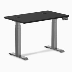 Black Desky Dual Mini sit-stand desk, 40x24 inch, with grommets and space gray frame.